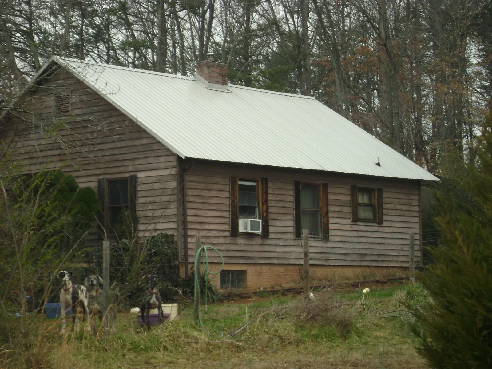 White metal roof on an old wood sided farmhouse, from a Metal Roof Installation job in Palomar Mountain